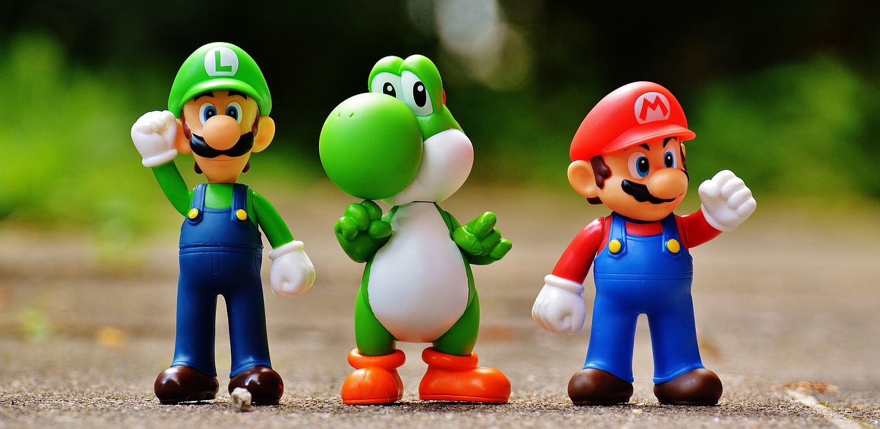 Luigi, Yoshi and Mario figures lined up.